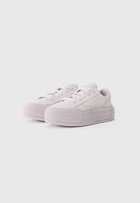 Light purple suede sneakers with a thick platform sole, featuring flat laces, rounded toe, and textured accents along the side.
