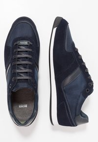 Marina sneakers med en kombination av mocka och meshmaterial, med en vit mellansula, grå snören och logodetalj på tungan.