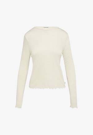 Lange mouw top van lichtgewicht stof, gebroken witte kleur, met een ronde halslijn en een gekartelde zoom.