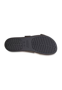 Semelle en caoutchouc noir avec un motif de texture en relief. Présente un bord lisse et un détail de logo. Taille indiquée comme W 7.