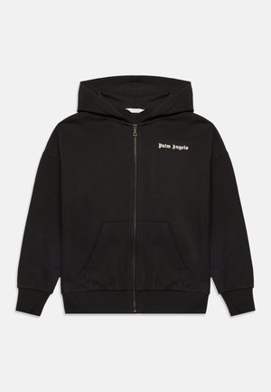 Sweat à capuche noir zippé avec poches avant et texte blanc ""Palm Angels"" sur la poitrine gauche, affiché sur un fond uni.