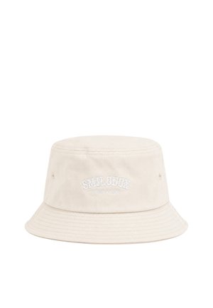 Bob beige clair avec bord cousu et texte brodé blanc "SMILODOX STREET WEAR" au centre à l'avant.