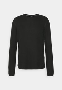 Pull noir à manches longues avec col ras du cou texturé, coupe ajustée et petite étiquette de marque près de l'ourlet.