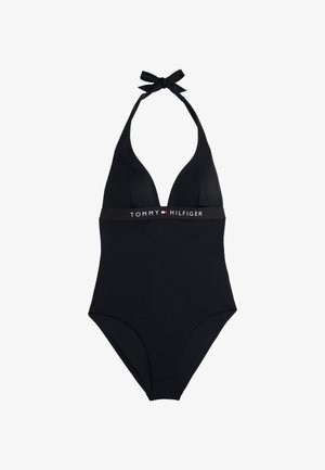 Czarny jednoczęściowy strój kąpielowy z głębokim dekoltem w kształcie V, zawiązaniem na halter oraz poziomą markową taśmą z napisem "TOMMY HILFIGER" w białym i czerwonym kolorze.