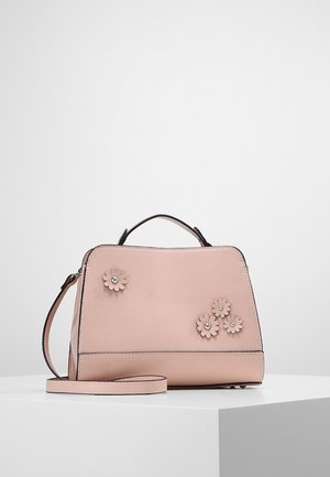 Blush pink handbag with top handle, removable shoulder strap, and four small leather flower embellishments with silver centers.