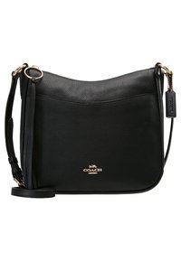 Black textured leather crossbody bag with gold-tone hardware and a front logo, featuring an adjustable strap and a hanging leather tag.