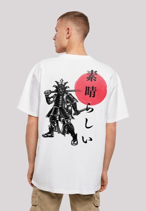 White t-shirt featuring a black samurai graphic with a red circle and Japanese text. Short sleeves and casual fit, made from soft fabric.