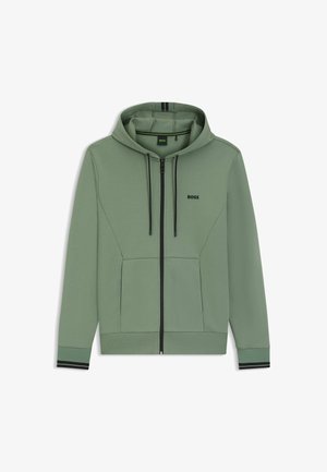 Green zip-up hoodie made of soft fabric. Features a front logo, contrasting black zipper, and striped accents on cuffs.
