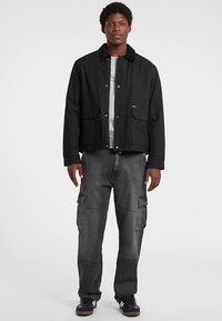 Guess Jeans Välikausitakki - schwarz