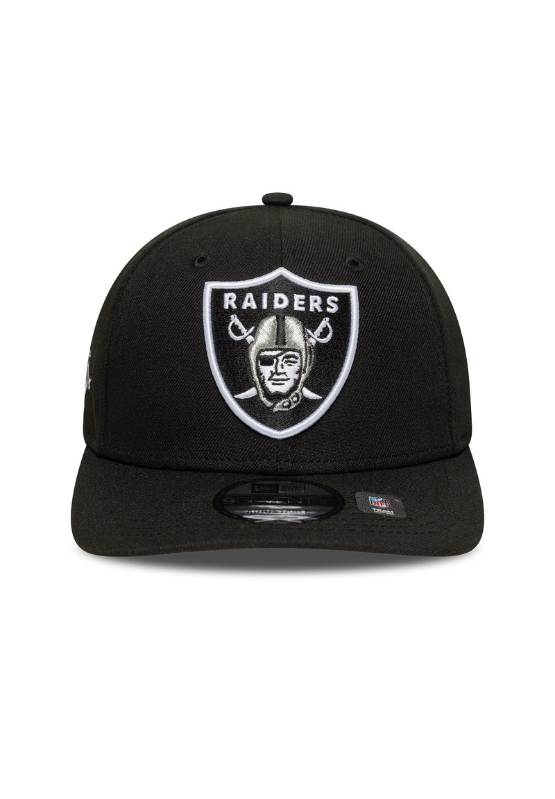 Black snapback cap with a curved brim, featuring an embroidered Raiders logo in black, white, and silver on the front.