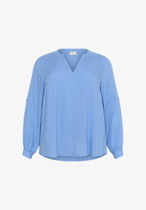 Hele sinine pluus V-kaelusega, pika varrukaga ja tekstureeritud kangast. Omab kokku kootud mansette ja veidi vabamat lõiget.