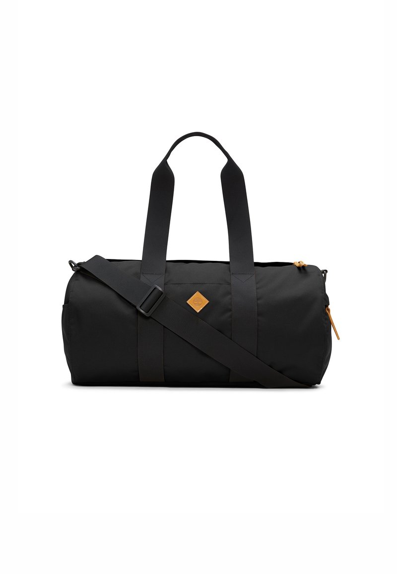 Black duffle bag made of durable fabric, featuring two short handles, a long adjustable strap, and a leather patch logo. Zippered compartment.
