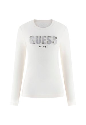 Tricou lung cu mânecă albă, decorat cu elemente argintii care scriu "GUESS" și "EST. 1981" în negru. Material moale cu decolteu rotund.