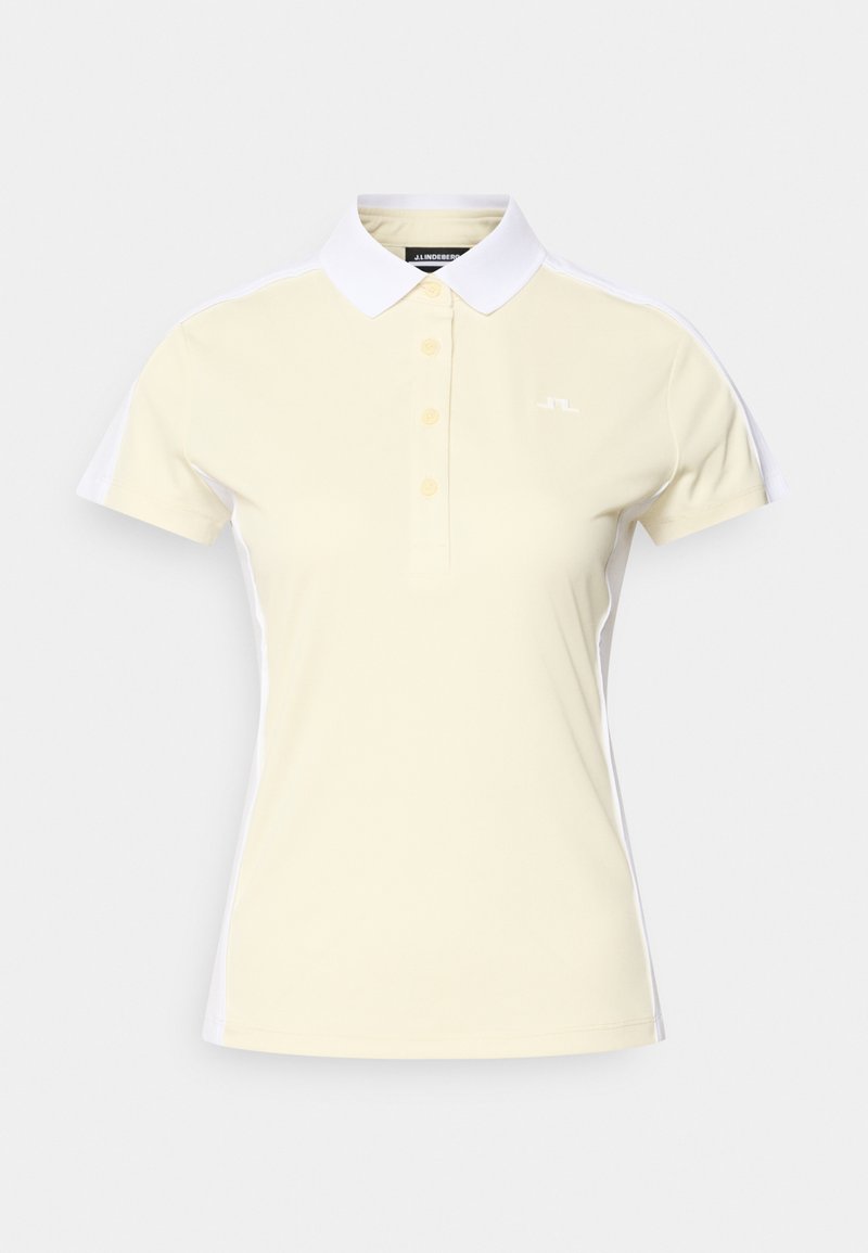 Ανοιχτό κίτρινο πόλο με λευκό γιακά και πλαϊνά στοιχεία. Διαθέτει τρία κουμπιά και διακριτικό λογότυπο στο στήθος. Ομαλή υφή.