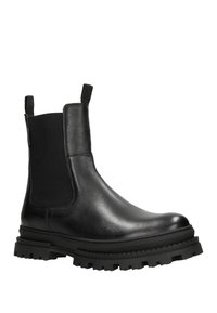 Bottines en cuir noir avec panneaux latéraux élastiques, languettes de tirage et semelle en caoutchouc robuste avec un profond motif de crampons pour une meilleure traction. Texture lisse.