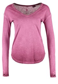 Pitkähihainen, vaaleanpunavioletti t-paita pehmeästä, kevyestä kankaasta, jossa on V-aukko ja pyöristetty helma sekä nappikoristeet hihoissa.