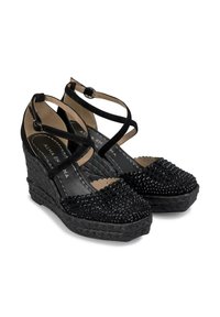 Scarpe con zeppa nere con una base intrecciata testurizzata, decorazioni di perline sulla punta e cinturini incrociati regolabili. Interno foderato.