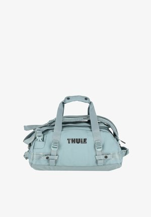 Light blue duffel bag with dual handles, adjustable strap, multiple pockets, and Thule logo. Made from durable, water-resistant material.