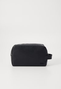Black leather toiletry bag with a textured surface, rectangular shape, top zip closure, and a side handle for easy carrying.