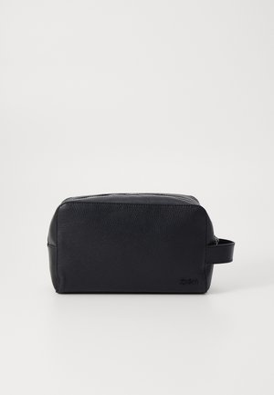 Must must beeblöö, millel on tekstureeritud pind, ristkülikukujuline kuju, ülemine tõmblukk ja külgkäepide, mis muudab selle mugavaks kaasaskandmiseks.