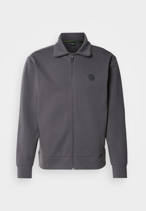 Gray zip-up jacket made of smooth fabric, featuring a high collar, ribbed cuffs, and a hexagon logo on the left chest.