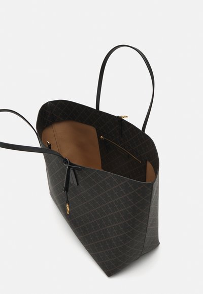 Black patterned tote bag with two long handles, open top, and a brown interior featuring a zip pocket and golden hardware accents.