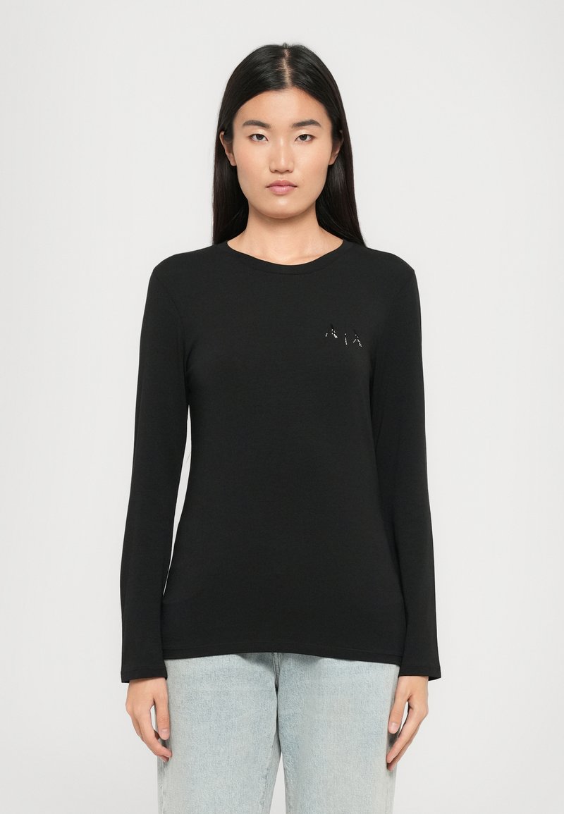 Schwarzes Langarmshirt aus glattem Stoff mit Rundhalsausschnitt und kleinem gestickten Logo auf der Brust.