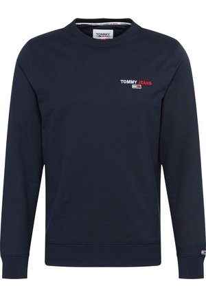 Navyblauer Sweatshirt mit Rundhalsausschnitt und langen Ärmeln, mit kleinem "Tommy Jeans" Logo und Flaggenemblem auf Brust und Ärmelbündchen.