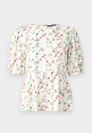 Blusa blanca con estampado floral colorido, con mangas cortas abullonadas y un corte holgado. Hecha de una tela ligera y texturizada.