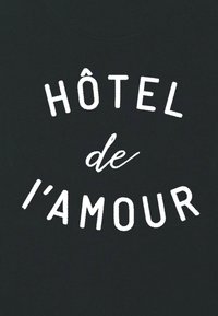 Vit text som lyder "HÔTEL de l'AMOUR" i stiliserade typsnitt på en solid svart bakgrund.