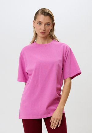 Pink short-sleeve t-shirt made of soft cotton, featuring a relaxed fit and a round neckline, with subtle logo accent in the center.