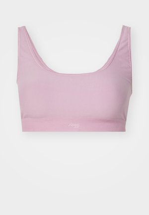 Light pink cotton bralette with a wide band, scoop neckline, and no underwire. Features stitched edges and a subtle logo at the base.