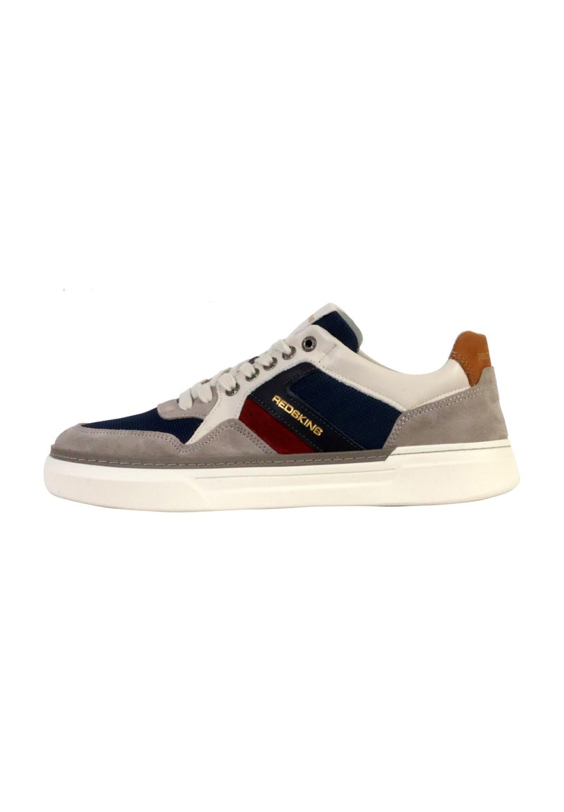 Sneakers with a grey suede upper, navy textile accents, and red branding. White rubber sole with brown rear heel detail. Classic athletic design.