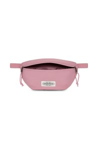 Sacchetto di stoffa rosa dalla forma arrotondata, con apertura a zip superiore e un'etichetta del logo visibile. Materiale testurizzato con fodera interna liscia.