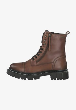 Bottine en cuir marron avec un bout arrondi, un laçage à l'avant, une fermeture éclair sur le côté et une semelle en caoutchouc robuste avec des rainures profondes pour l'adhérence.