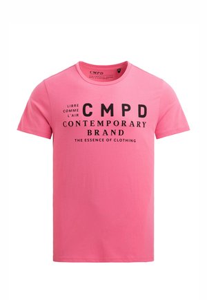 Pink short-sleeve T-shirt with black text "LIBRE COMME L'AIR CMPD CONTEMPORARY BRAND THE ESSENCE OF CLOTHING" on the front.