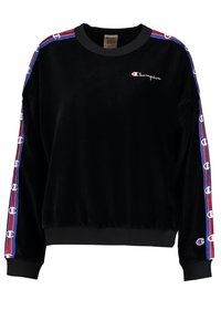 Sweatshirt en velours noir avec des rayures d'accent bleu et rouge sur les manches, présentant un petit logo sur la poitrine et une taille côtelée.