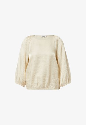 Kremowy pulower o fakturowanej powierzchni, z okrągłym dekoltem i oversize’owymi rękawami ściąganymi przy mankietach. Etykieta widoczna przy szyi.