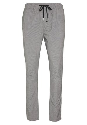 Lichtgrijze broek met een subtiel ruitpatroon, elastische tailleband en zwarte trekkoorden met metalen uiteinden.