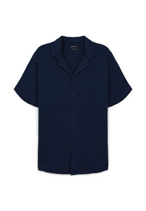 Chemise à manches courtes bleu marine avec col cranté. Fabriquée en tissu texturé avec une coupe décontractée et un éclat subtil, dotée de boutons à l'avant.