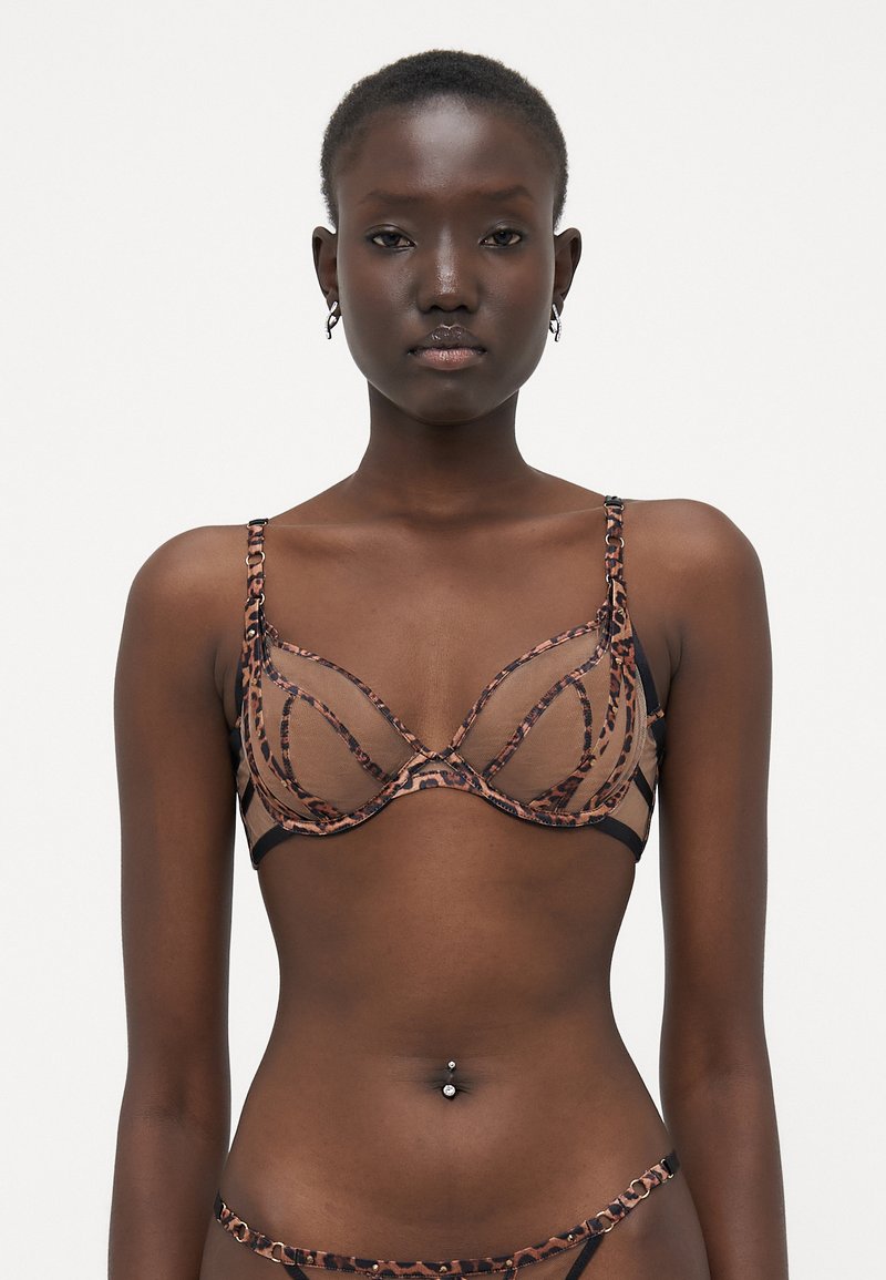 Sostén con un diseño de estampado de leopardo, fabricado con un material de malla transparente, soporte de aros y tirantes ajustables en negro.