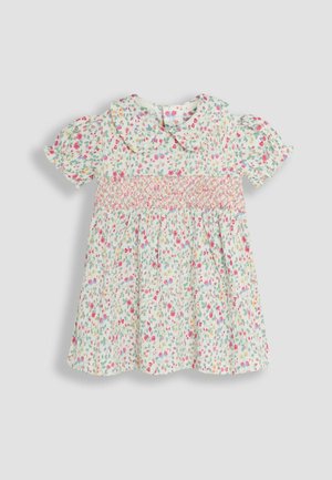 Ziedu kleita ar īsām puff piedurknēm, apkakles izgriezumu un smockotu korseti. Gaismas zaļš pamats ar rozā, sarkaniem un ziliem ziedu rakstiem.