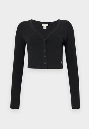 Sort cropped cardigan lavet af ribbet stof. Har lange ærmer, en V-hals og en række af seks knapper foran. Minimalistisk design.