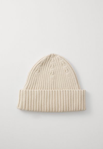 Knit beanie in light beige, featuring a ribbed texture and rolled cuff at the bottom, highlighting a simple, streamlined design.