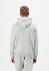 Sweatshirt à capuche gris en tissu doux, avec une coupe décontractée, poche kangourou et poignets et ourlet côtelés. Vue arrière montrée.