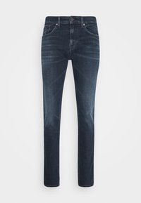 Mörkblå denimjeans med rak skärning, femfickorsdesign och knappstängning. Diskret blekning och sömnadsdetaljer runt fickorna.