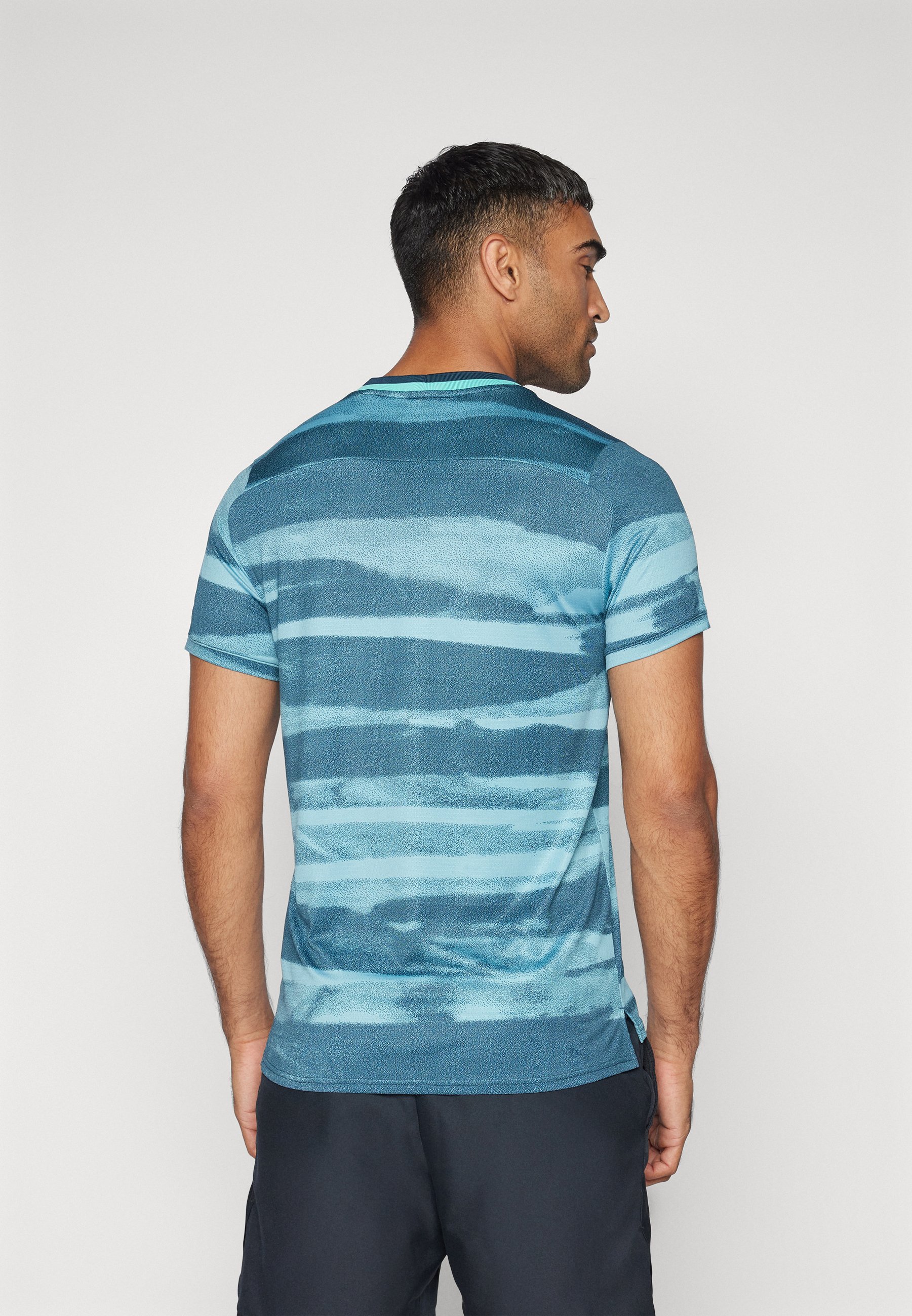 white and turquoise nike shirt