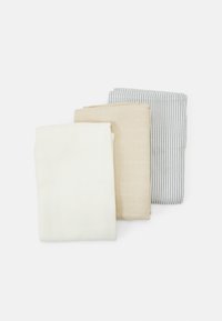 Three folded textiles in white, beige, and blue-striped patterns. The fabrics feature a textured grid design for visual interest.