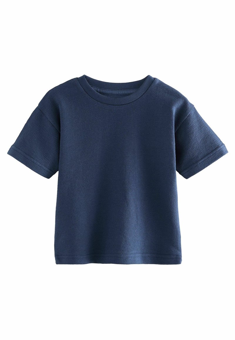 Navy blue bawełniana koszulka z krótkim rękawem, okrągłym dekoltem i teksturowaną powierzchnią; ma luźny fason i brak widocznych logotypów lub wzorów.