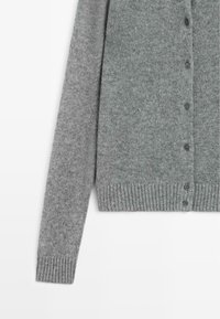 Cardigan grigio lavorato a maglia con maniche e fronte abbottonato, con polsini e orlo a coste, su sfondo bianco.
